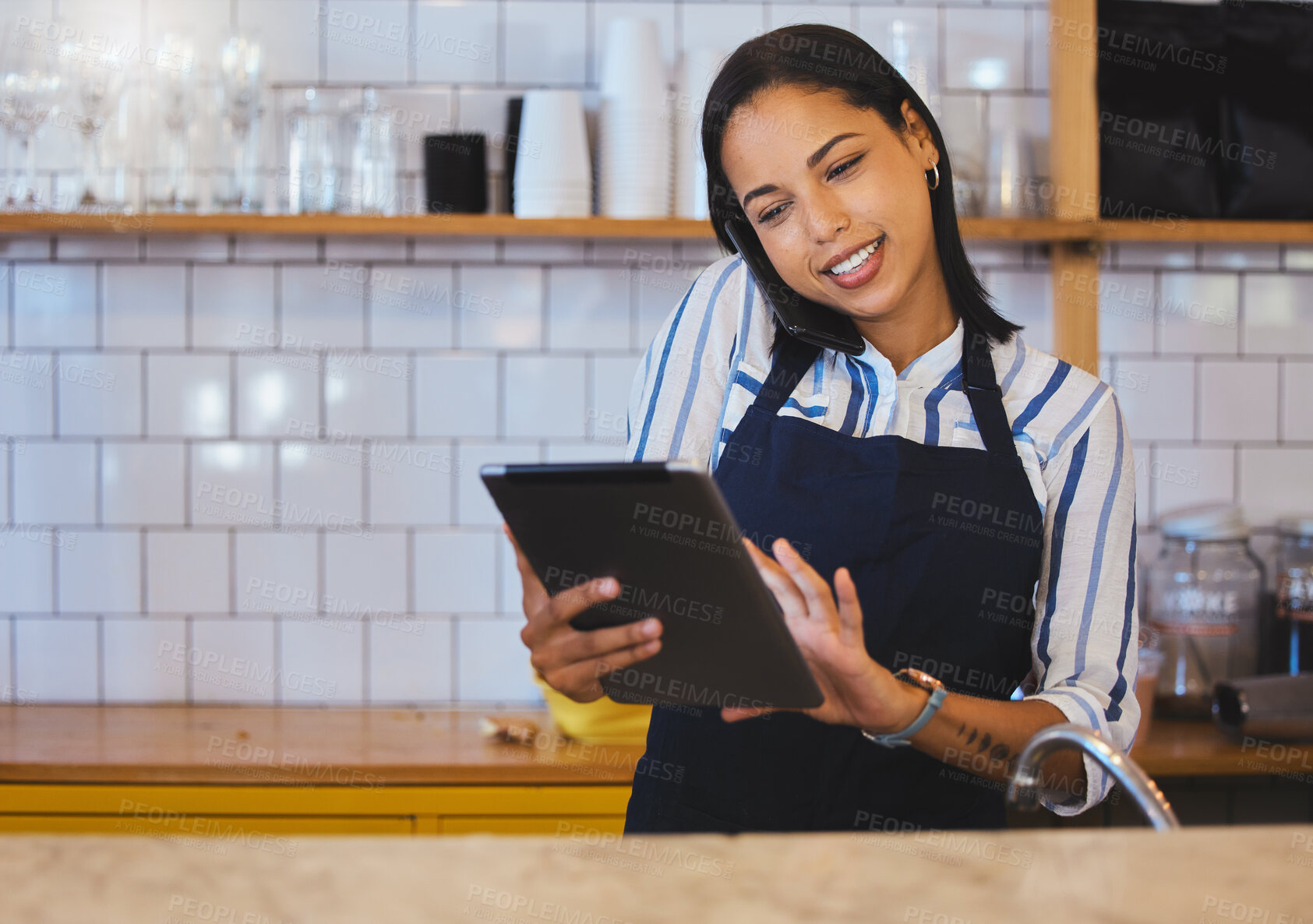 Buy stock photo Female cafe or small business manager on phone call, reading a digital tablet in her store. Startup business woman, entrepreneur or employee working in a coffee shop preparing online grocery sales
