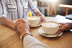 Coffee, break and dating couple holding hands on a romantic date at a cafe, restaurant or coffee shop. Man, woman or people touching, in love and romance on anniversary or valentines day together