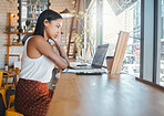 Woman on a laptop at a cafe, watching a video or typing and writing a report at a restaurant. Serious and focused student studying remotely at a coffee shop in the city, reading an email online. 