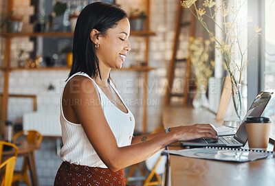 Buy stock photo Working, typing and happy digital online worker writing a work email on a computer in a coffee shop. Woman web writer with a smile busy with internet research at a cafe or restaurant on a laptop