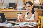 Student, drinking coffee in cafe on a laptop and on a video call, reading email, books or notebook. Smile, happy and writing business woman working on a computer with her phone in a restaurant.


