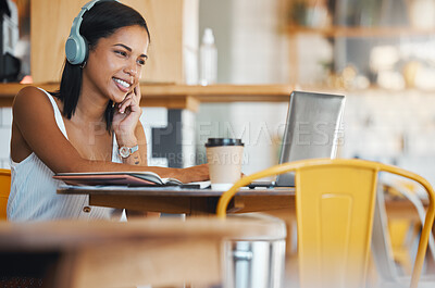 Buy stock photo Creative woman in coffee shop with headphones listening to music, watching online social media on laptop or planning digital seo strategy. Remote graphic designer busy video editing at Internet cafe