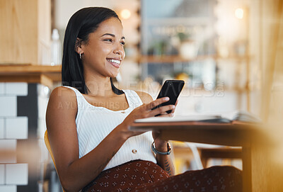 Buy stock photo Relaxing, texting a message or browsing social media on a phone by a young female student smile in a coffee shop. A happy woman thinking and searching the internet or chatting online at a cafe