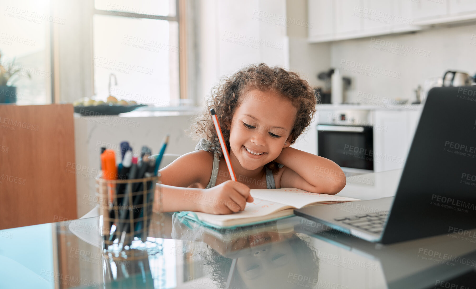 Buy stock photo Homework, education and student online learning writing and drawing in her kindergarten school notebook at home. Smile, happy and creative girl studying, fun and working on laptop via house internet