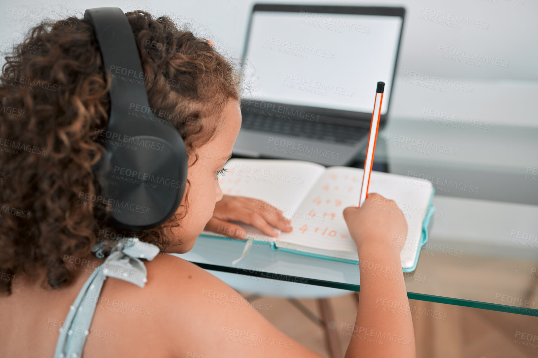 Buy stock photo Home, school and education of a girl writing, learning and working or study online on a laptop. Child, internet and student using technology for elearning at the house while listening to podcast.