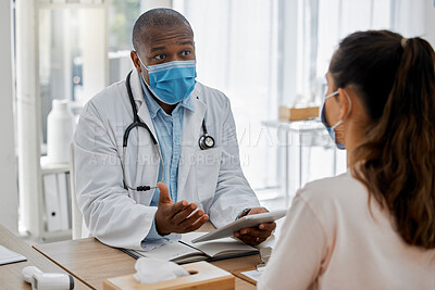Buy stock photo Doctor appointment by a woman consulting a healthcare or medical worker in an office about covid symptoms. Male African American GP talking to a patient and explaining covid19 regulations  