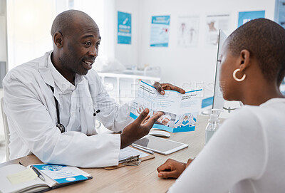 Buy stock photo A doctor giving patient hospital information at a clinic and explaining medical benefits to a woman in his office. African American GP or healthcare professional having a discussion with a female