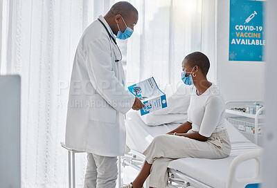 Buy stock photo Doctor, brochure and medical patient consulting about covid  while learning, gp about healthcare on hospital bed. Masks, support and woman communication on stay safety from virus, disease or sickness