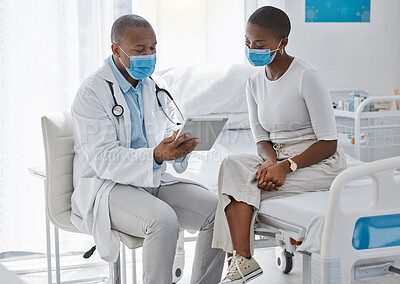Buy stock photo A doctor consulting a patient and talking to her about the covid virus using a tablet at the hospital or clinic. Female at her appointment or consultation with a healthcare or medical worker