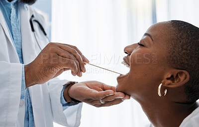 Buy stock photo Doctor, otolaryngologist or dentist with a medical instrument checking the throat for tonsils or oral cancer. Health, healthcare worker and wellness with an ent specialist examining a black woman    