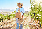 Grape farmer holding fruit basket from crops harvest and walking on farm, estate or pasture. Happy woman and garden field worker with countryside agriculture plants for wine industry, food and snacks