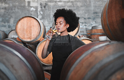 Buy stock photo Black winemaker smelling white wine in vineyard cellar, expert analysis by professional, proud female sommelier. Small business owner checking the smell, color and blend of alcohol, enjoying career