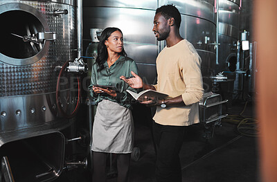 Buy stock photo Wine production workers using alcohol machine or distillery equipment in warehouse winery. Business sommelier expert woman and man talking and working on quality control maintenance with a checklist