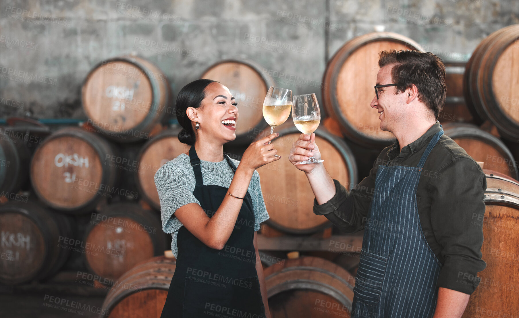 Buy stock photo Wine, glass and toast with a couple who drink alcohol in a cellar, distillery or winery estate together. Farming, collaboration and teamwork with a man and woman drinking and doing a cheers as a team