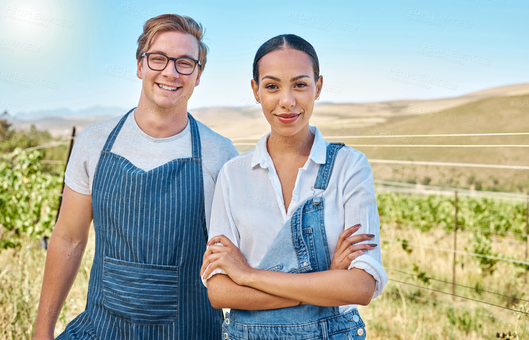 Buy stock photo Couple farming on a wine farm in summer, farmer gardening on a vineyard or field and smile with green sustainable lifestyle. Portrait of interracial man and woman with arms crossed for agriculture