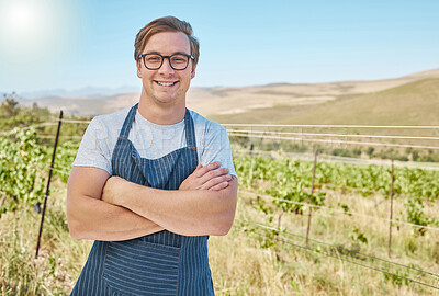 Buy stock photo Vineyard and happy farmer man in the countryside with smile at a farm in nature in summer. Health, agriculture and success portrait of a young worker on a field in sustainability on a sunny day.