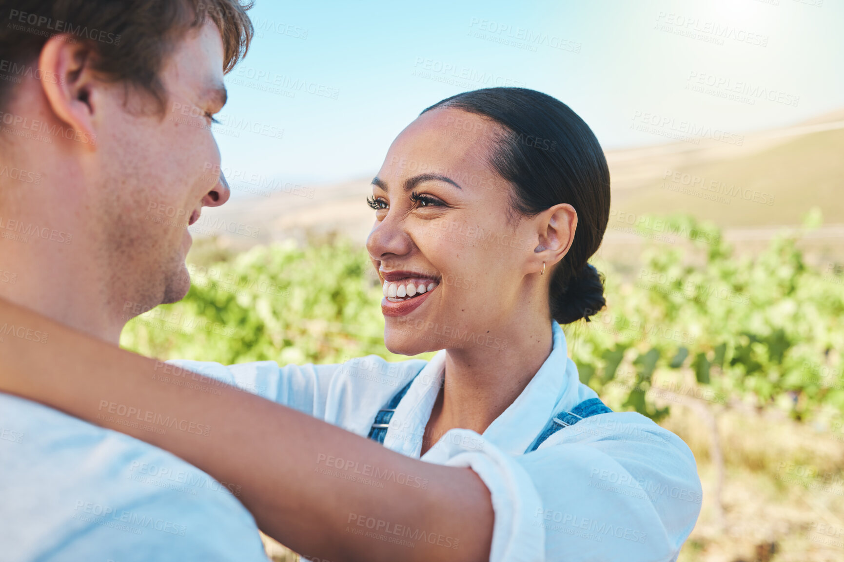 Buy stock photo Love, countryside and couple smile, loving and bond together on a sunny wine farm field and nature agriculture. Interracial, green and happy man and woman travel to a holiday vacation trip in summer