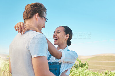 Buy stock photo Laughing, in love and happy interracial couple in hug, embrace or holding each other on wine tasting farm. Fun, playful or loving man and woman standing close and enjoying countryside vineyard estate