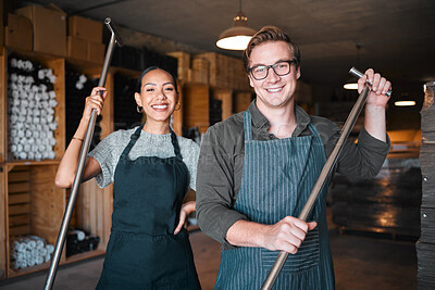 Buy stock photo Wine making workers with press tool or equipment inside a cellar, winery or distillery warehouse with bulk quality alcohol. Woman, man or sommelier people with smile portrait for industry background