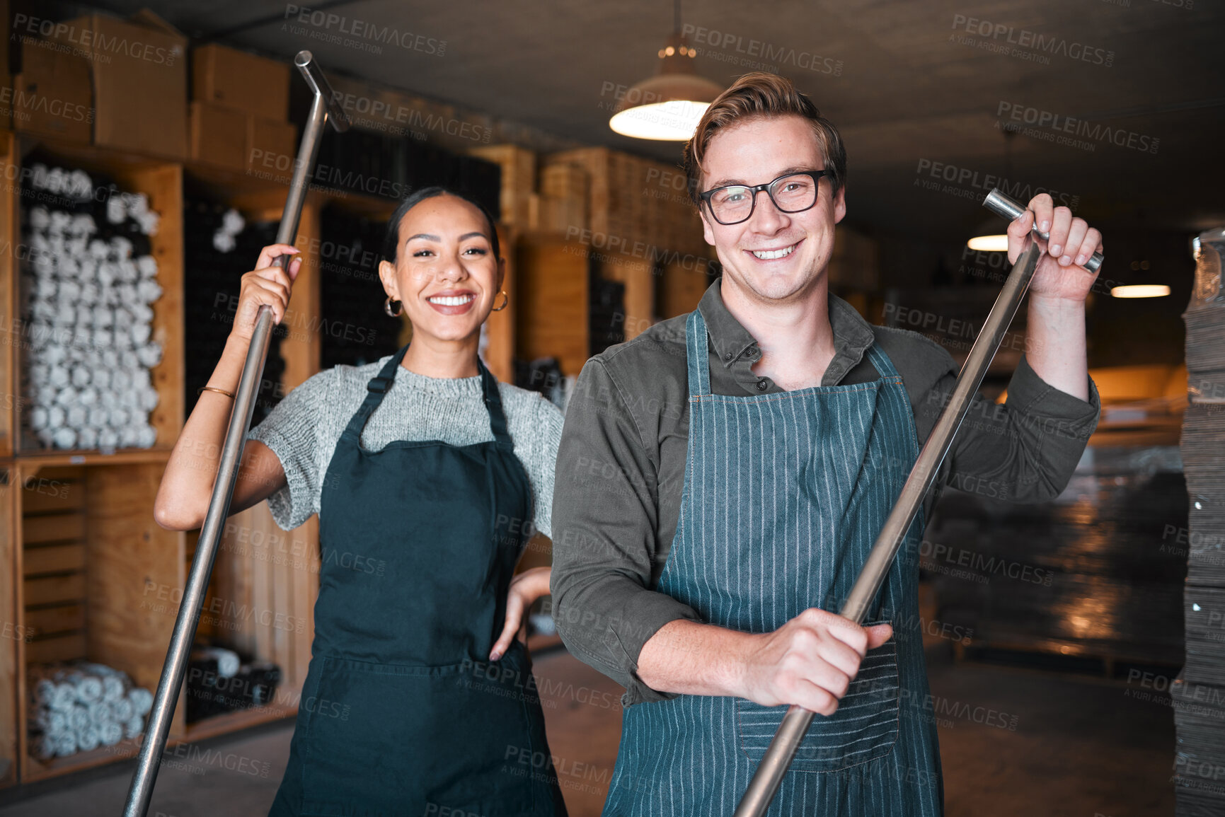 Buy stock photo Wine making workers with press tool or equipment inside a cellar, winery or distillery warehouse with bulk quality alcohol. Woman, man or sommelier people with smile portrait for industry background