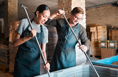 Buy stock photo Cellar workers, making wine and mixing open tank with stirring, pressing and crushing tool for alcohol production. Happy staff and merchants in factory distillery, winery and manufacturing warehouse