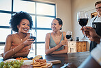 Happy, smile and friends drinking wine and eating healthy, fresh and organic fruit with toasted bread on a food table together. Diversity, glass, and relaxed people laughing at a fun dining party