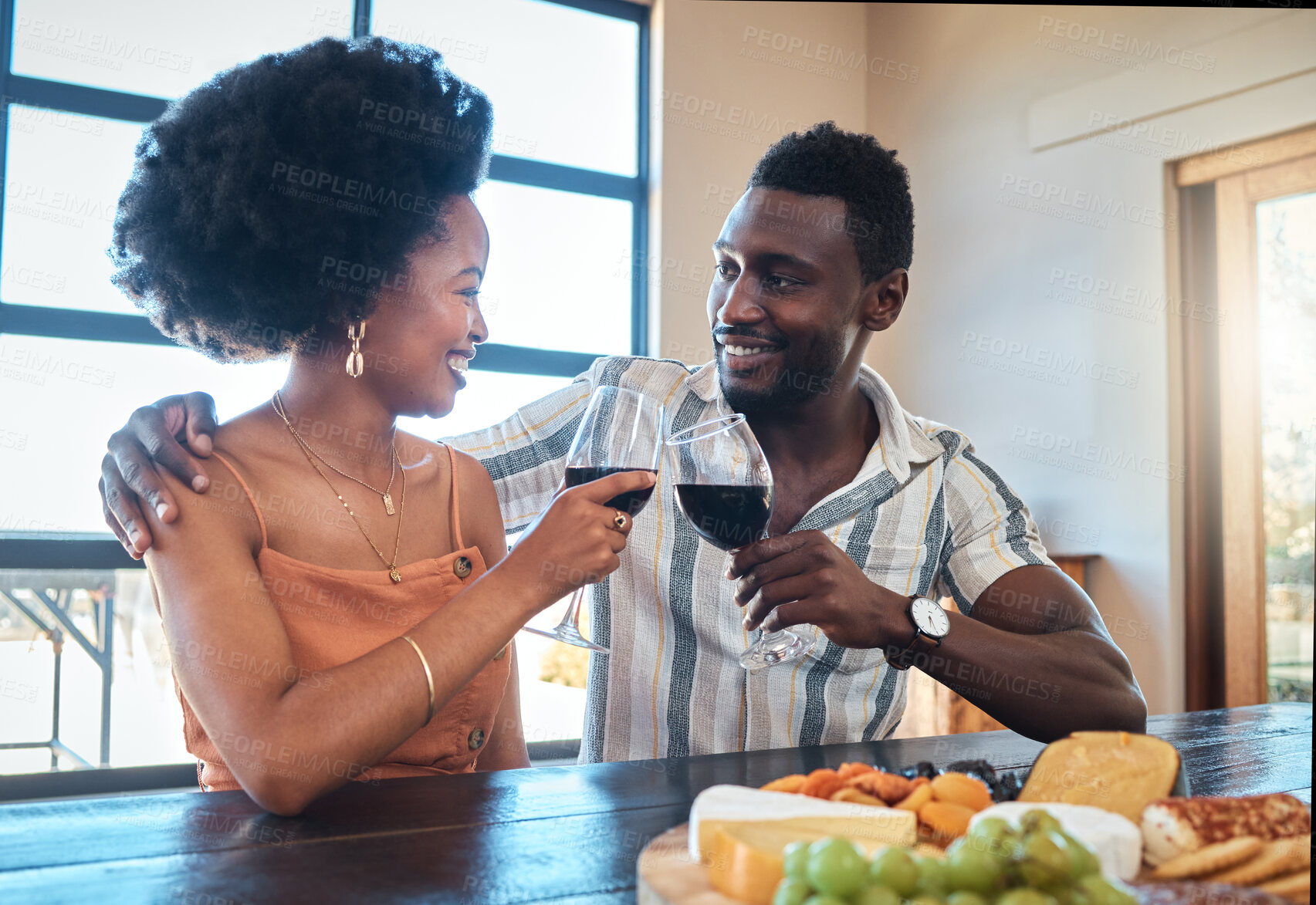 Buy stock photo  Celebration, love and black couple toasting with wine on a romantic date indoors, bonding and flirting. Lovers happy, in love and carefree, celebrating their anniversary and sharing intimate moment