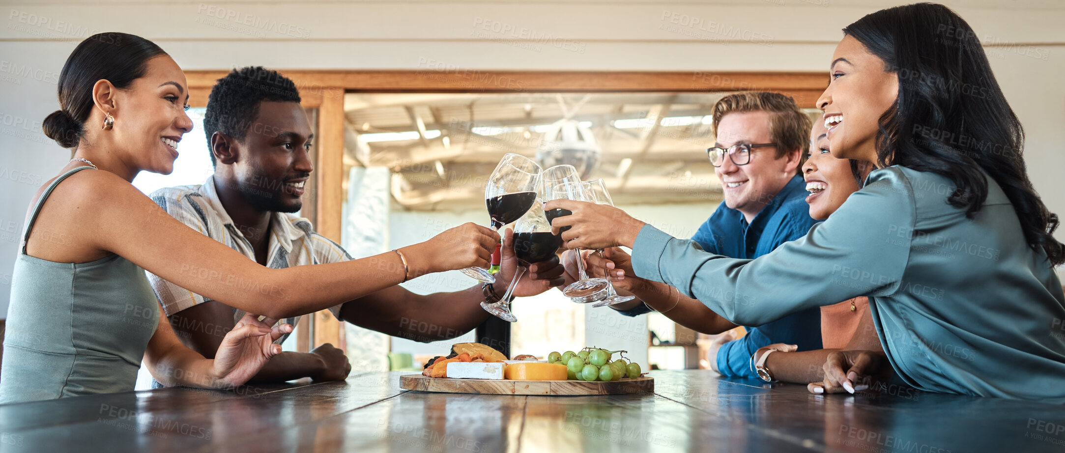 Buy stock photo Friends, wine tasting and toasting alcohol with drinking glasses in restaurant on farm, winery estate or countryside distillery. Diversity, bonding or happy men and women enjoying vineyard red merlot