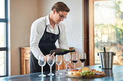 Buy stock photo Waiter, wine tasting, and bartender with glass at fine dining vineyard restaurant in countryside. Professional sommelier  pouring quality and luxury alcohol drinks for winery expert  masterclass.