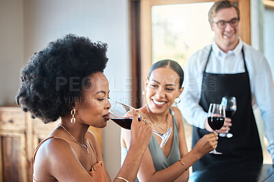 Buy stock photo Beautiful women friends taste a red wine glass together for brunch party in a luxury restaurant. Happy woman with an afro drinking with her friend at a distillery restaurant for alcohol with a smile