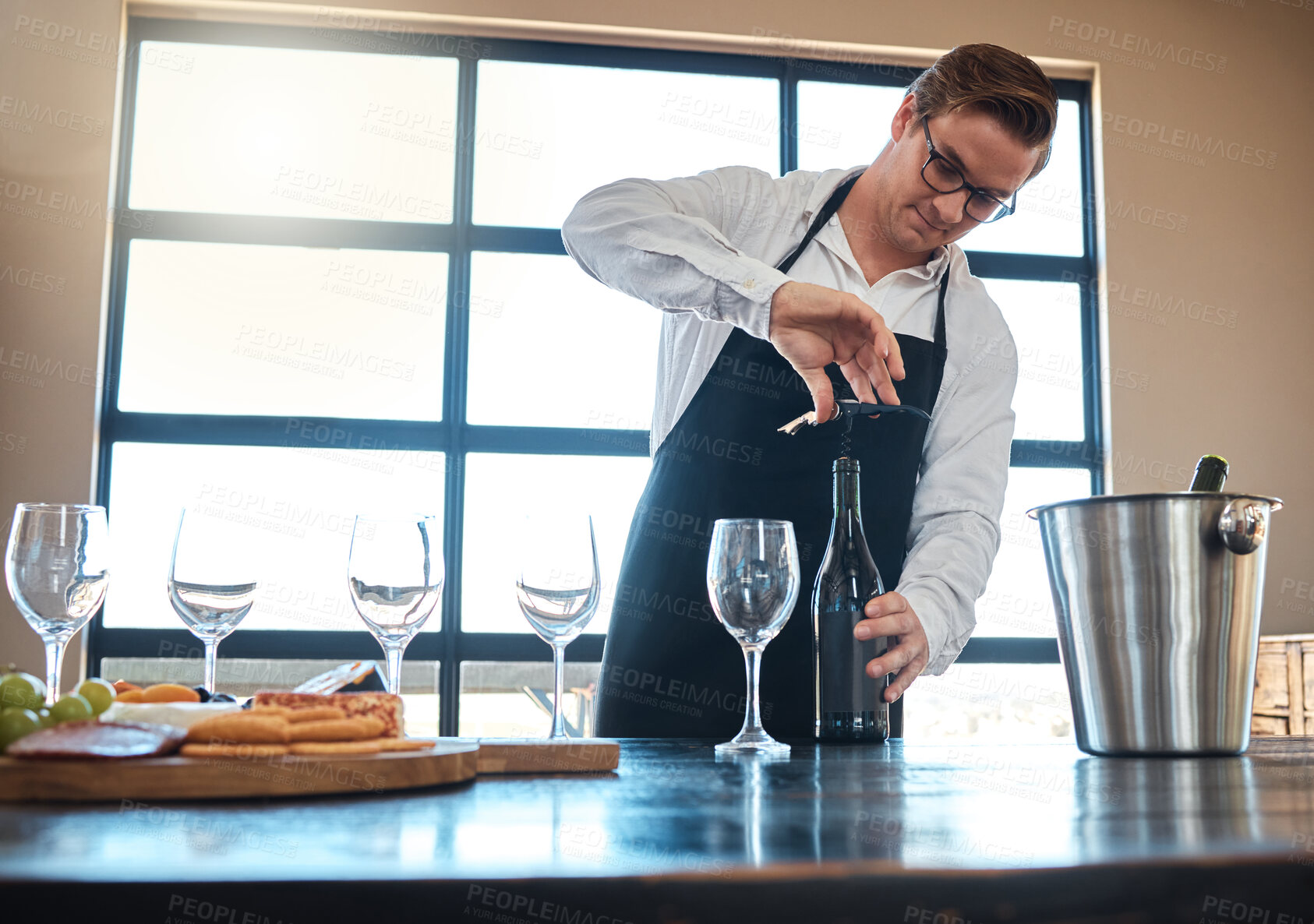 Buy stock photo Bartender with red wine tasting at luxury restaurant or vineyard and vintage alcohol bottle and glasses for fine dining, culinary or hospitality industry. Sommelier service with quality alcohol drink