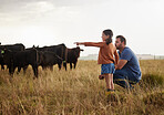 Family, dairy farming and farmer with child, daughter and girl pointing, showing and watching cows or cattle. Father and curious kid bonding on farm estate with meat, beef and food industry livestock