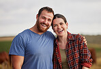Happy, carefree, and excited farmer couple standing outdoors on cattle or livestock farmland. Portrait of relaxed activists relaxing on organic or sustainable land smiling and enjoying nature