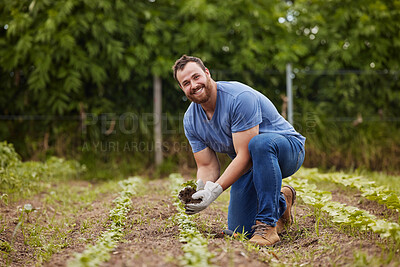 Buy stock photo Farmer planting plants or vegetable crops on an organic and sustainable farm and is happy for his seedlings. Excited, joyful and carefree male nature activist who is passionate about sustainability