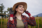 Happy, rustic female farmer checking weather for outdoor farming, harvesting and countryside living. Woman on a farm land or grass field looking at cloud sky with smile for crops growth development