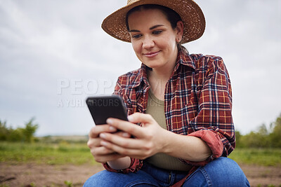 Buy stock photo Farmer texting or scrolling on social media on a phone for online sustainability tips relaxing on an organic farm. Nature activist browsing and searching the internet for sustainable farming ideas