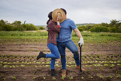 Buy stock photo Couple kiss, agriculture farmer or garden worker on countryside field, sustainability nature or growth landscape. Bonding, romantic and fun man and woman working with environment plant and earth soil
