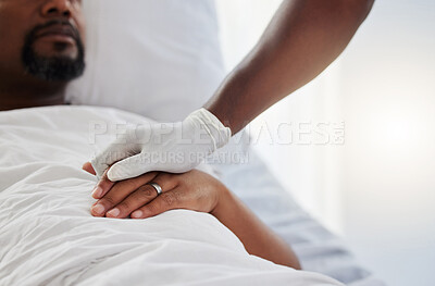 Buy stock photo Cancer, death and medical support with a patient and nurse in a hospital for health, wellness and love. Closeup of the hand of a doctor giving comfort and care to a man lying in a clinic bed