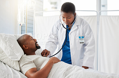 Medical doctor doing heart health checkup on patient in bed, listening for healthy heartbeat and consulting black man after surgery at hospital. Sick male person doing tests with healthcare worker