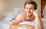 Relax, home and bedroom with a young man lying in bed in the morning after waking up in his house. Resting, relaxation and time off with a male looking comfortable and happy with a smile on a weekend