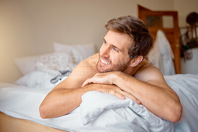 Buy stock photo Home, house and happy relax man in bedroom, bed thinking  and relaxing with a smile in the morning. Portrait of resting, relaxation and time off with a male looking comfortable on a weekend