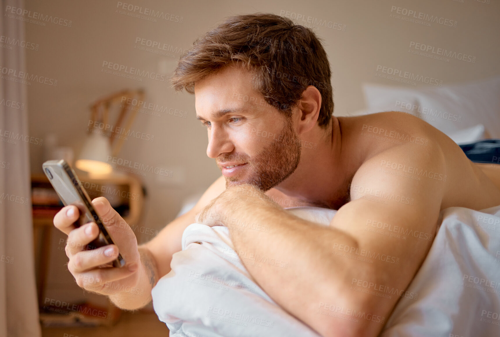 Buy stock photo Phone web dating app search, internet streaming or texting of an attractive man in a bedroom bed. Digital, online and social media on a 5g mobile while a guy relax at a house with technology