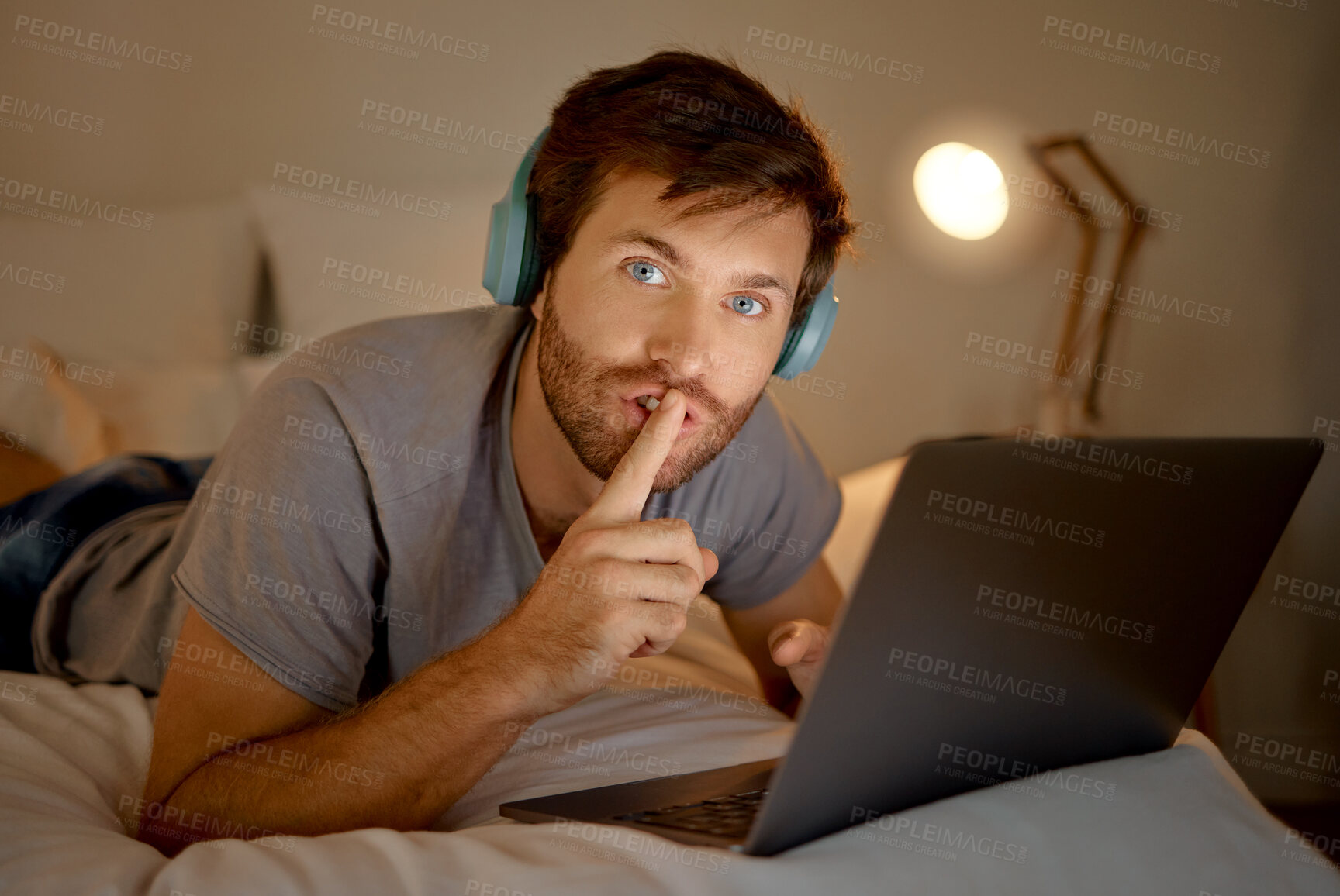 Buy stock photo Laptop, portrait and quiet hand gesture from man trying to focus. Insomnia or workaholic reading emails at night in his bedroom. Silence expression from person for silent environment while working. 