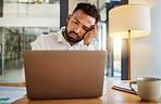 Stress, burnout and sad eyes of businessman on laptop working late on an email at house or home. Headache, mental health and disappointed worker working on finance, accounting or financial tax
