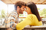 Love, happy couple relax on a patio at new house or home on the weekend. Young married man and woman bonding on valentines day or marriage anniversary with intimate look before a kiss