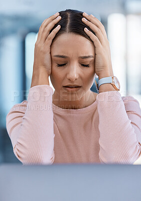Buy stock photo Stressed, tired and sick young woman with a headache feeling sad and overworked in an office. A frustrated, ill and unhappy female employee with a migraine suffering from pain and depression