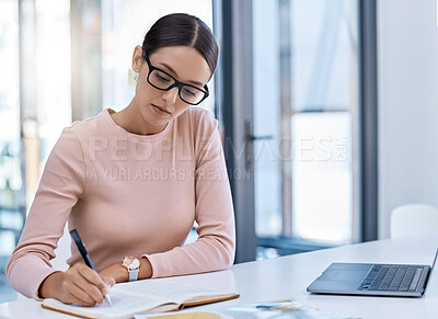 Buy stock photo Planning, thinking and strategy with business woman writing notes while working on a laptop in a corporate office. Professional assistant plan schedule and meetings, using journal to write reminder