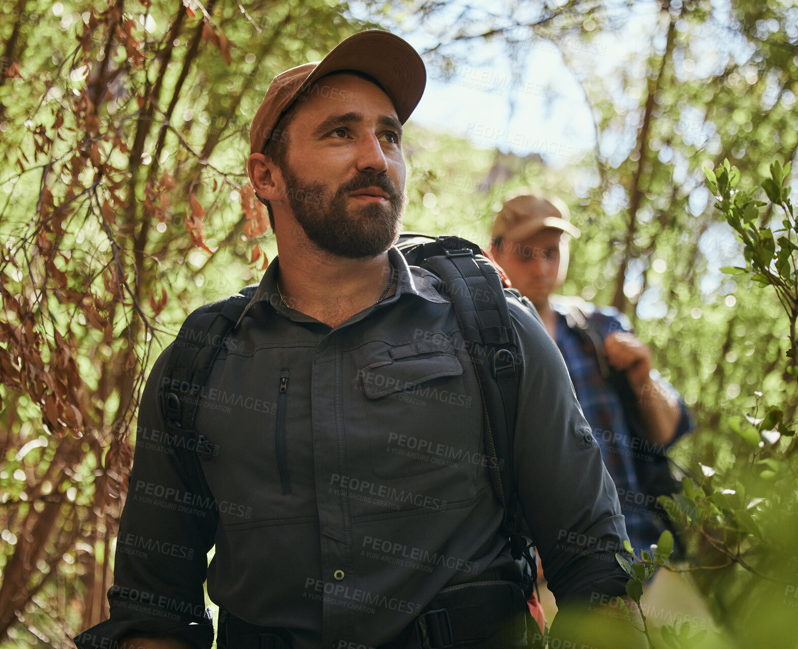 Buy stock photo Friends hike in nature environment while journey in a green forest together, being active and bonding outdoor. Male walking on path in the woods, enjoying a physical challenge and trekking adventure
