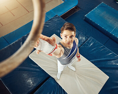 Buy stock photo Sport, exercise and training ring for gymnastics exercise with a boy gymnast student in a gym. Top focus of an athlete about to do a fitness, wellness and sports workout to train for a performance