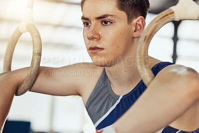 Buy stock photo Sport, exercise and training rings for a gymnastics athlete or gymnast in a gym. Fit and active sportsman doing fitness, wellness and sports workout to train his strength and flexibility